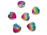 Pink, yellow, and blue rainbow aura heart crystal pendant from GemstoneGO with a loose, polished gemstone crystal.
