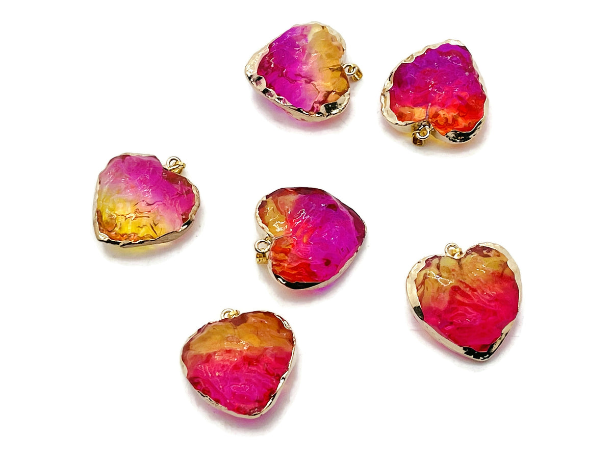 Pink and yellow rainbow aura heart crystal pendant from GemstoneGO, showcasing a vibrant, loose gemstone with iridescent rainbow hues.
