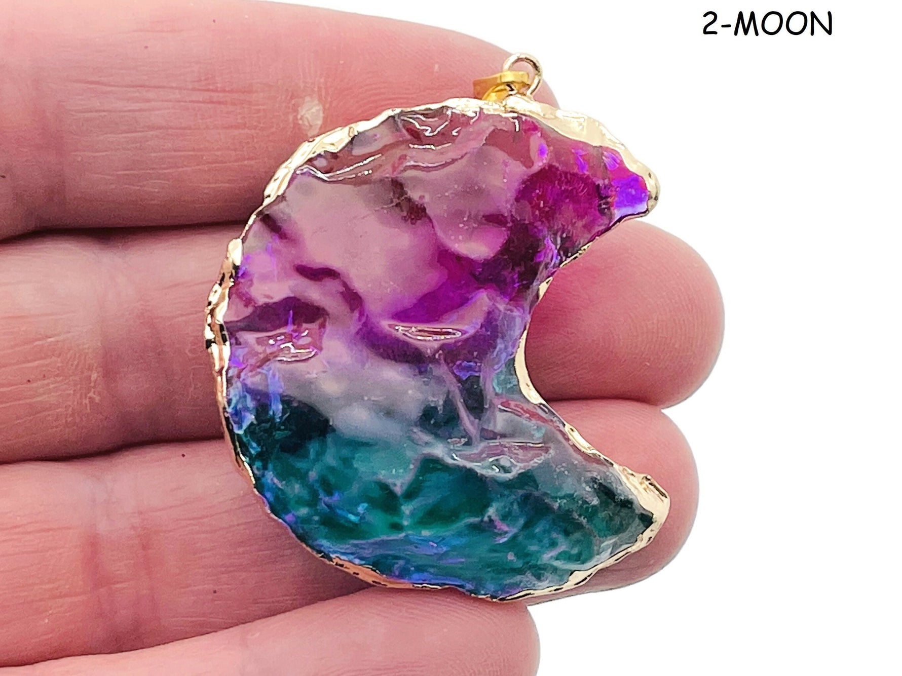 Rainbow Aura Heart crystal pendant featuring moon, star, and heart shapes from GemstoneGO, showcasing vibrant, iridescent gemstone details.