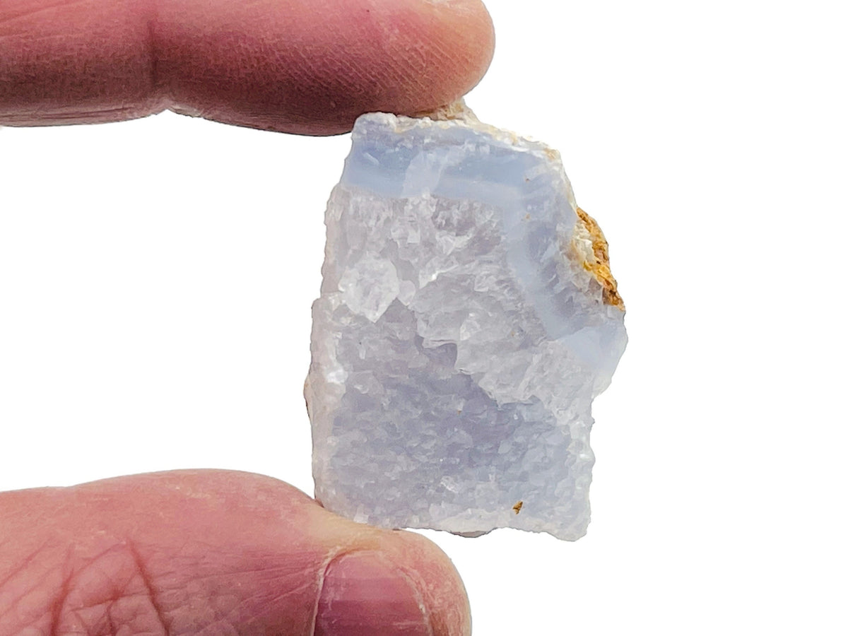 Raw Blue Lace Agate gemstone from GemstoneGO showing a light blue, banded natural stone with rough texture and intricate patterns.