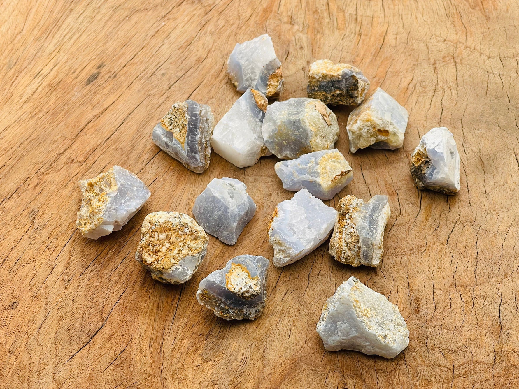 Raw Blue Lace Agate gemstone from GemstoneGO, showcasing its light blue and white banded patterns in natural form.