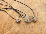 Desert Rose Selenite necklace with crystal gemstone pendant on a corn-colored cord, showcasing natural mineral textures and warm tones.