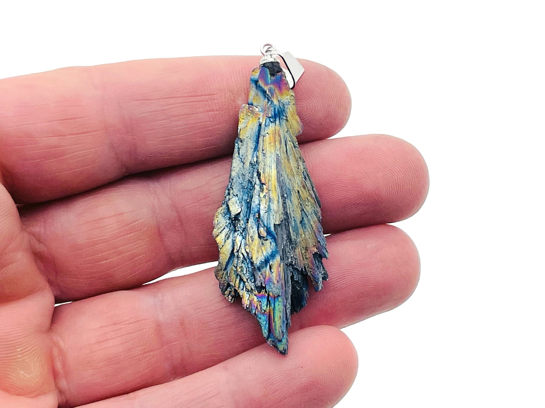 Rainbow Kyanite fan-shaped crystal pendant with titanium accents from GemstoneGO, showcasing vibrant, iridescent gemstone details.