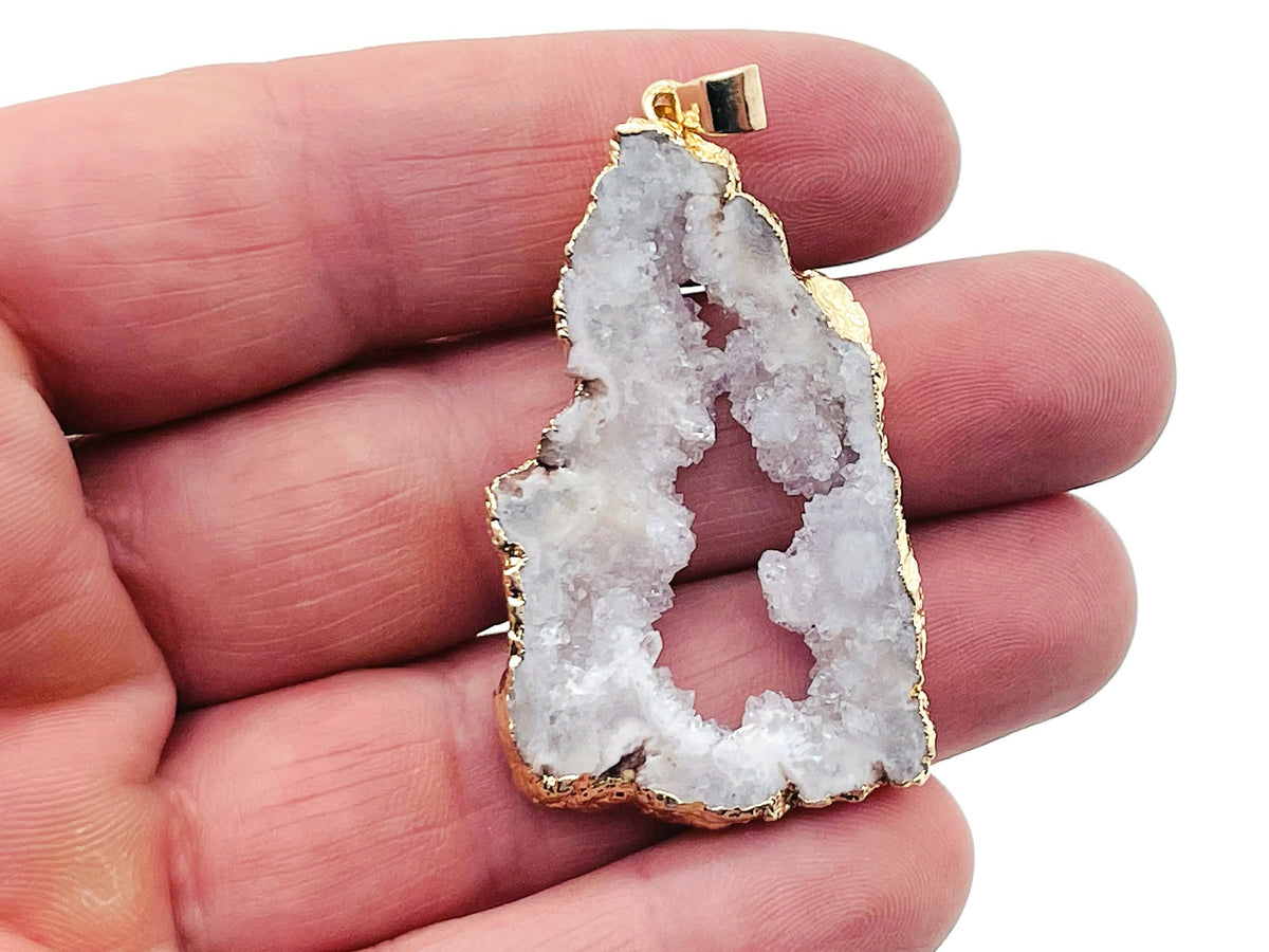White agate geode druzy slice crystal pendant with natural sparkling crystals, featuring a polished edge and a silver bail attachment.