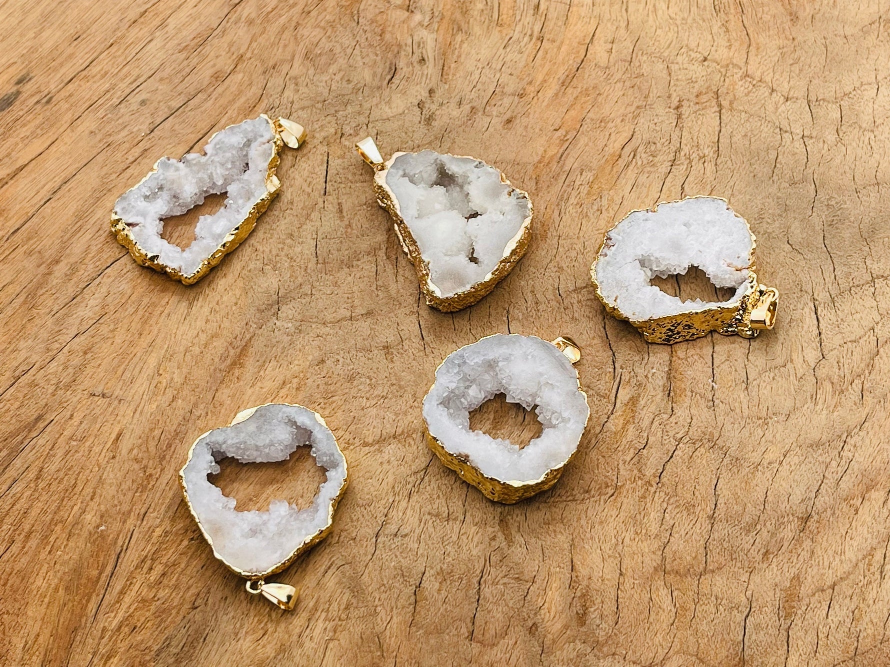 White agate geode druzy slice pendant from GemstoneGO, showcasing a sparkling crystal-filled geode with a smooth white agate exterior.