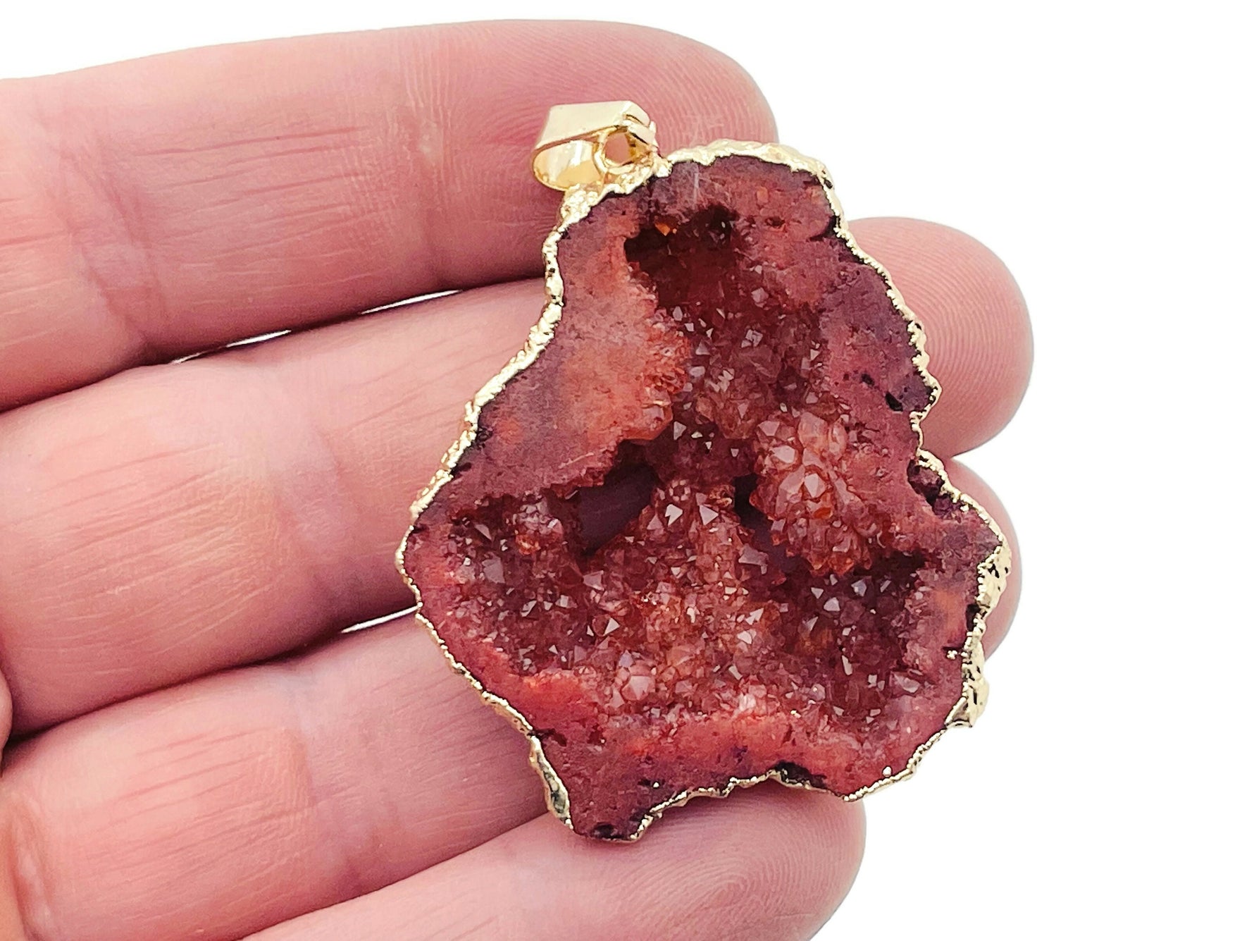 Red Agate geode druzy slice crystal pendant with natural textured surface, featuring vibrant red tones and gemstone details.