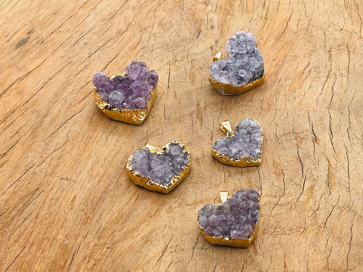 Amethyst heart cluster crystal pendant by GemstoneGO, showcasing a purple amethyst gemstone with a heart shape and natural crystal texture.