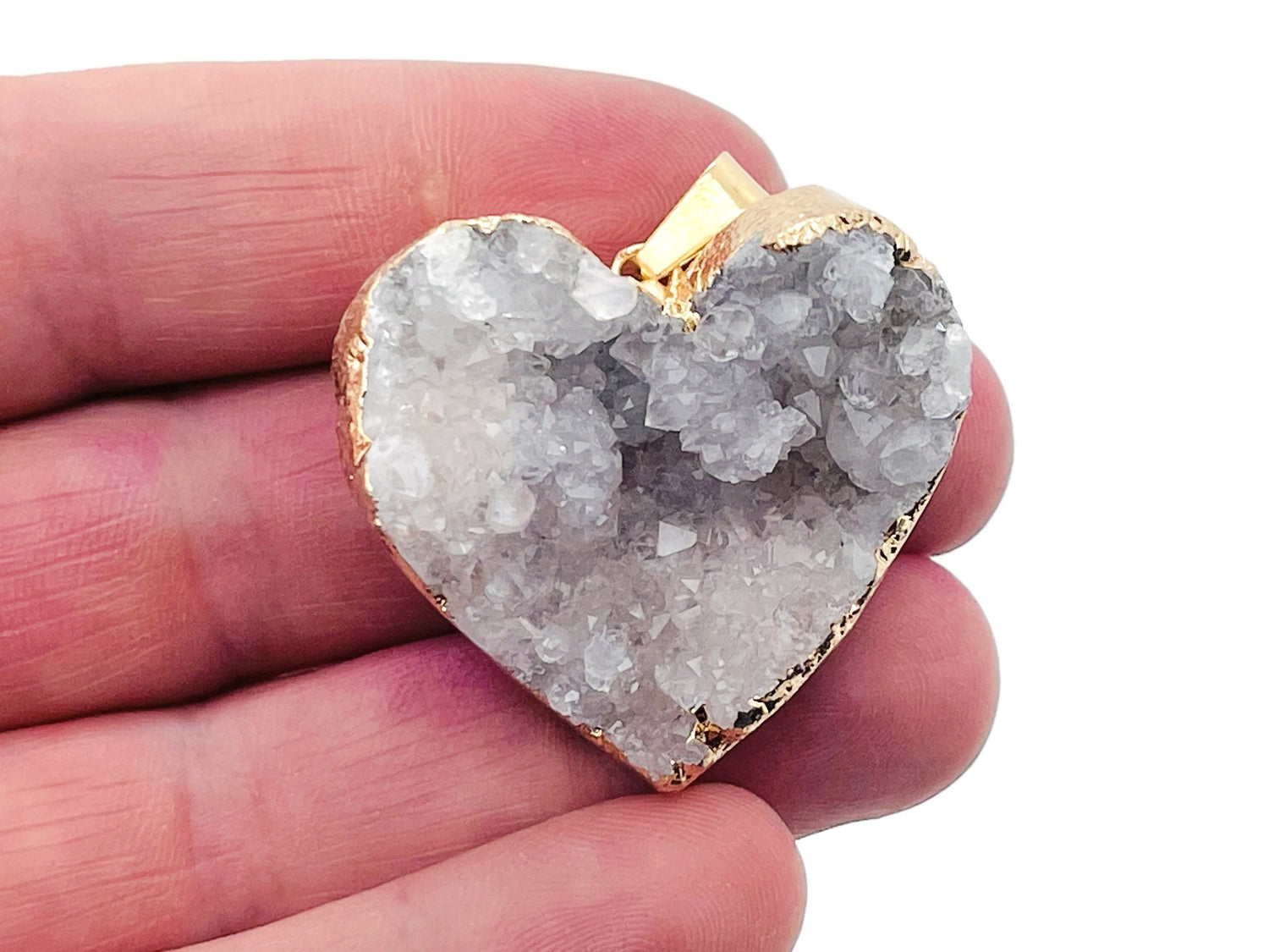 Quartz heart cluster crystal pendant from GemstoneGO featuring a polished heart-shaped quartz gemstone with natural crystal points.
