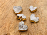 Quartz heart cluster crystal pendant from GemstoneGO featuring a natural quartz heart-shaped cluster on a silver chain.