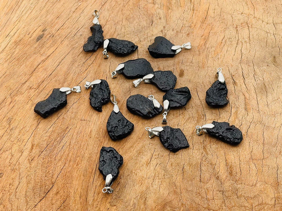 Tektite pendant featuring Tibetan Tektike meteorite gemstone, showcasing a polished, natural stone pendant on a simple cord.
