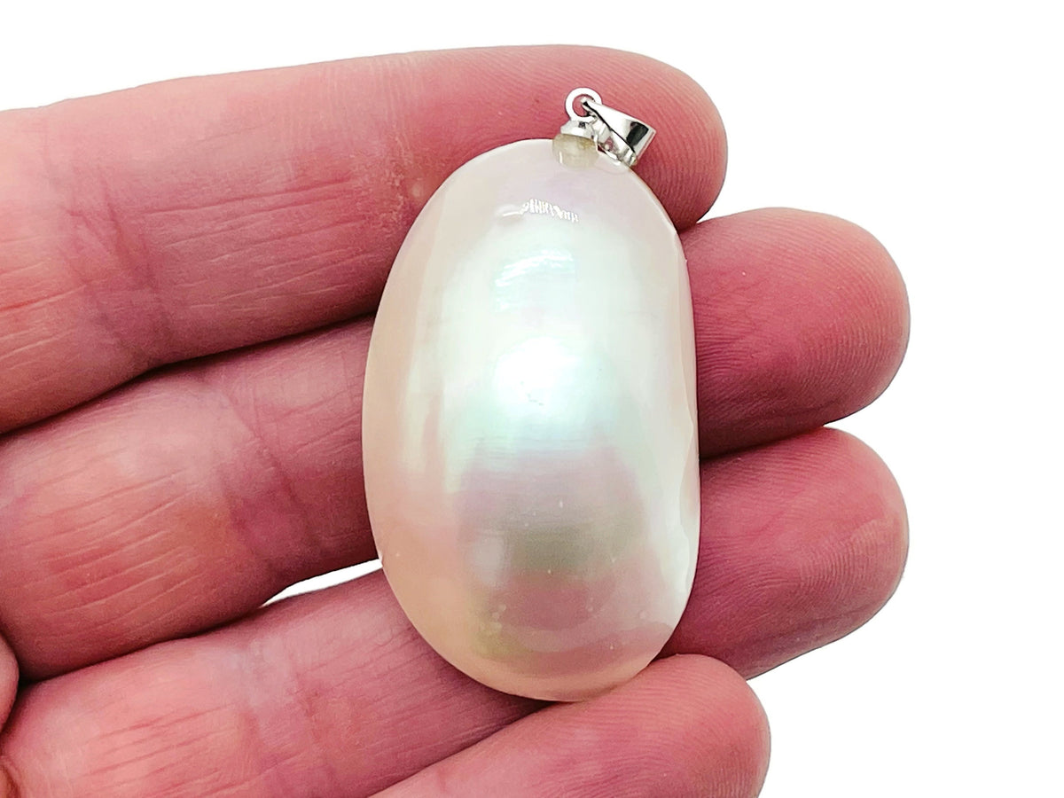White natural pearl pendant from GemstoneGO, shown with a silver setting, ideal for making jewelry, with bulk crystal accents.