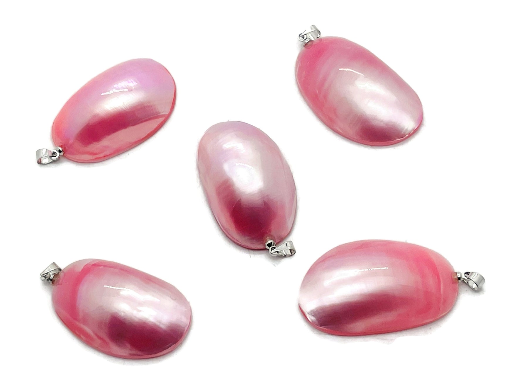 Pink natural pearl pendant with a silver setting, displayed with bulk crystal beads, suitable for jewelry making by GemstoneGO.