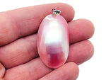 Pink natural pearl pendant from GemstoneGO, showcasing a delicate pearl with a jewelry-making setting on a neutral background.