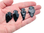 Black obsidian arrowhead carving gemstone with pointed tip and detailed texture, perfect for jewelry or collection.