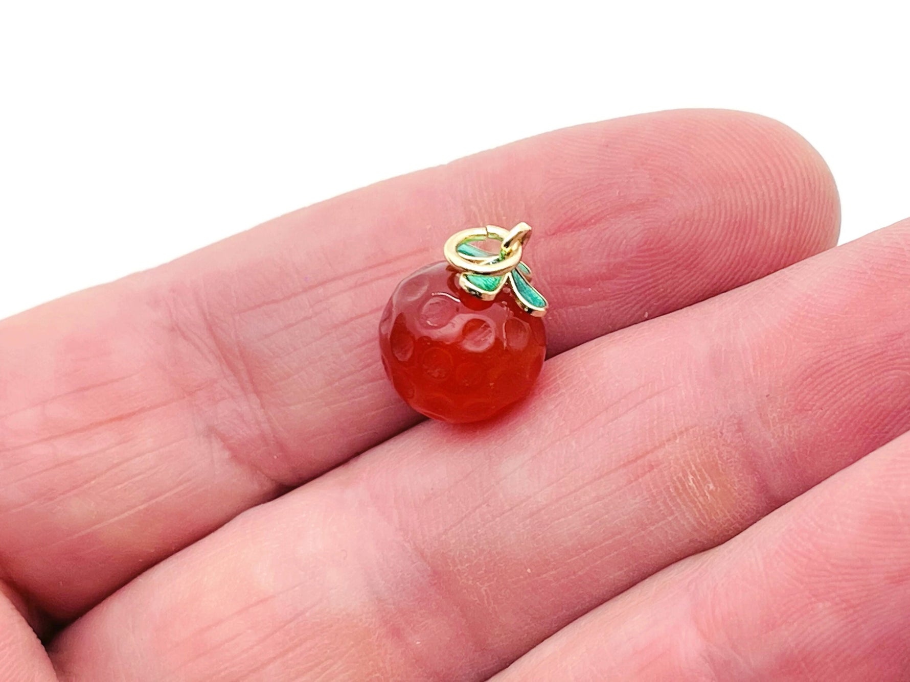 Carnelian crystal pendant from GemstoneGO with a polished orange gemstone and silver-tone bail for jewelry making.