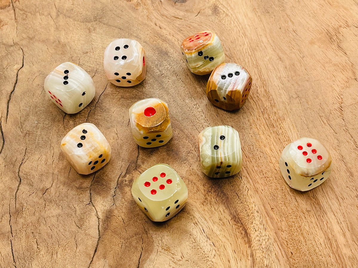 Carved gemstone crystal dice made from Afghanistan jade, featuring intricate gemstone craftsmanship by GemstoneGO.