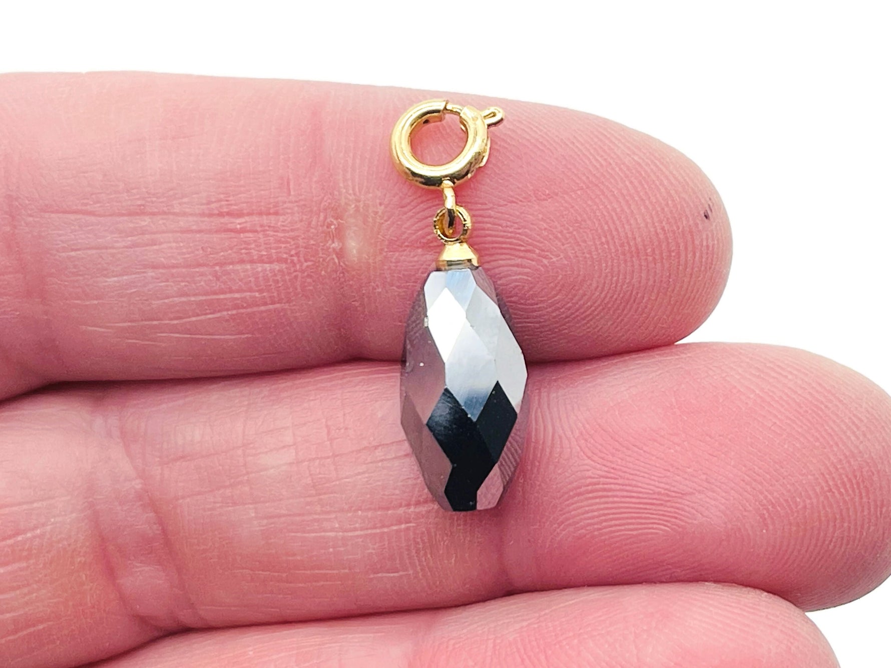 Close-up of a terahertz crystal pendant from GemstoneGO, showcasing its clear, polished gemstone for jewelry making.