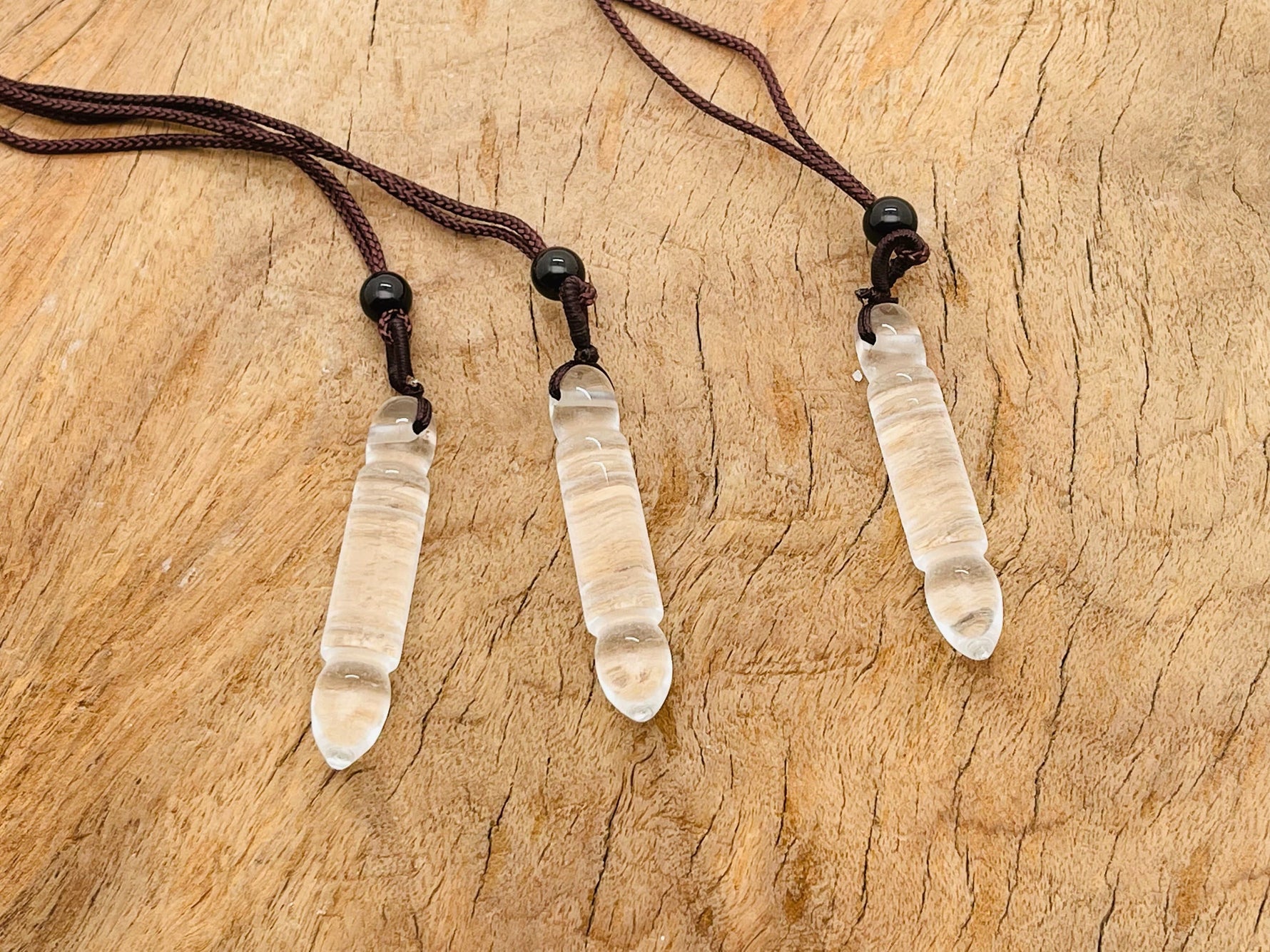 Clear Quartz bullet crystal necklace from GemstoneGO featuring a sleek, polished pendant on a delicate chain.