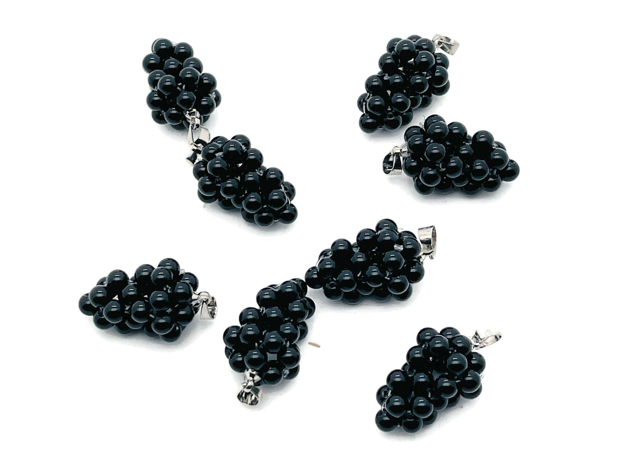 Obsidian Grape Crystal Pendant by GemstoneGO featuring a detailed crystal grape design on a silver chain.