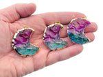 Blue-purple Rainbow Aura Moon Crystal pendant with love stone design by GemstoneGO, showcasing iridescent rainbow hues and moon shape.