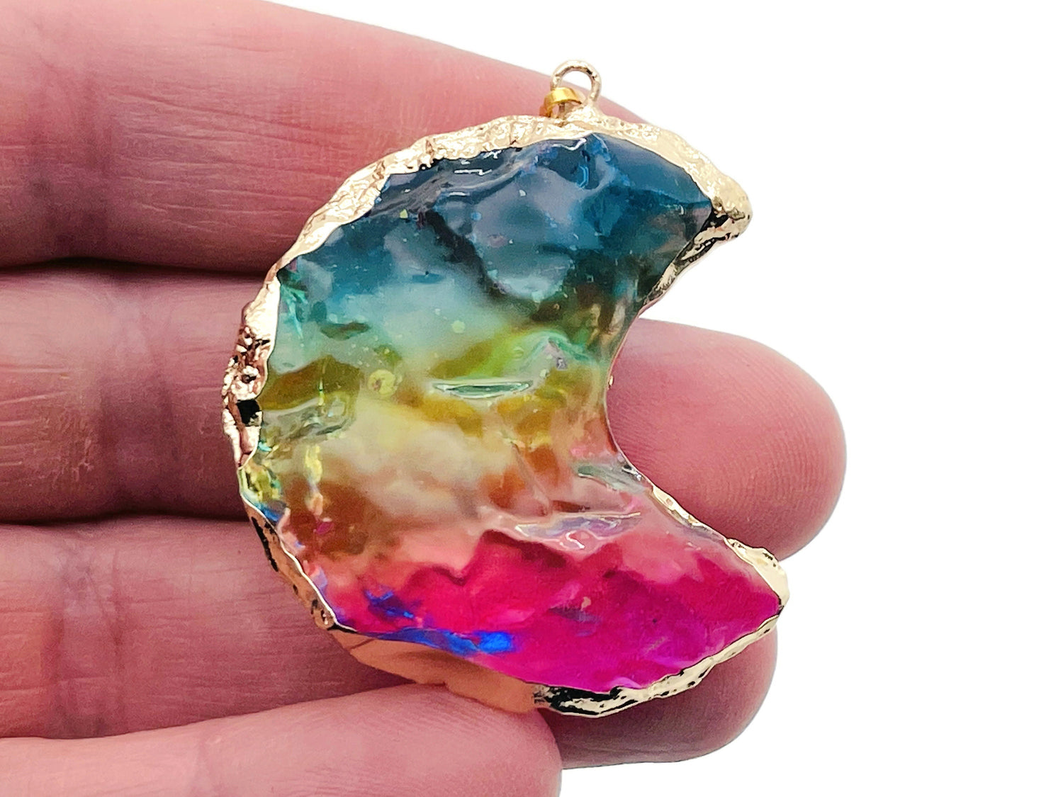 Blue, yellow, and pink rainbow aura moon crystal pendant by GemstoneGO, showcasing a vibrant, loose moon-shaped crystal.