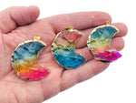 Blue, yellow, and pink rainbow aura moon crystal pendant from GemstoneGO, showcasing a loose crystal with vibrant iridescent colors.