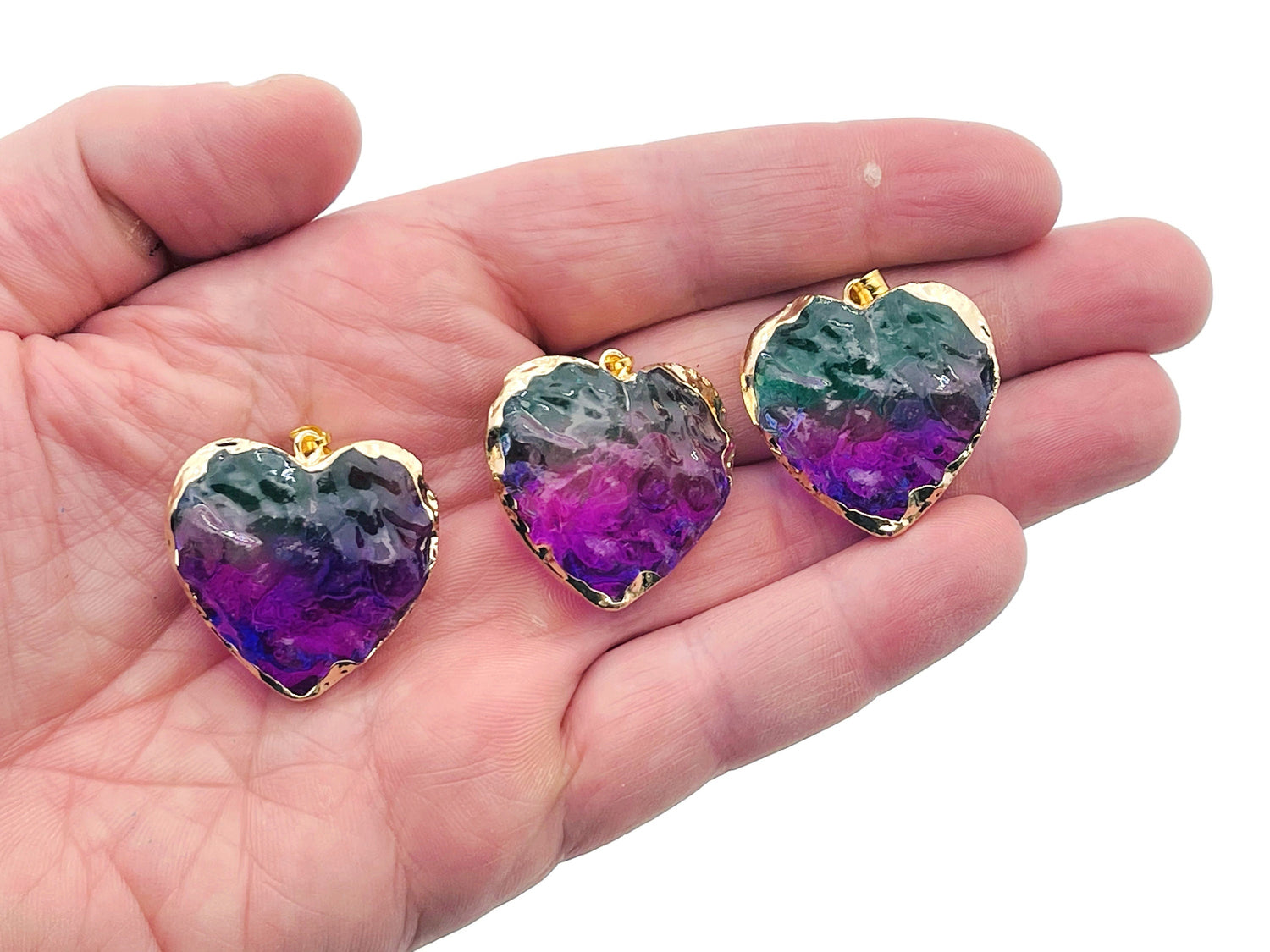 Green and purple Rainbow Aura Heart Crystal pendant from GemstoneGO featuring a vibrant, loose heart-shaped aura crystal.