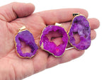 Pink agate geode druzy slice pendant with natural crystal formation, featuring a vibrant pink and white color pattern.
