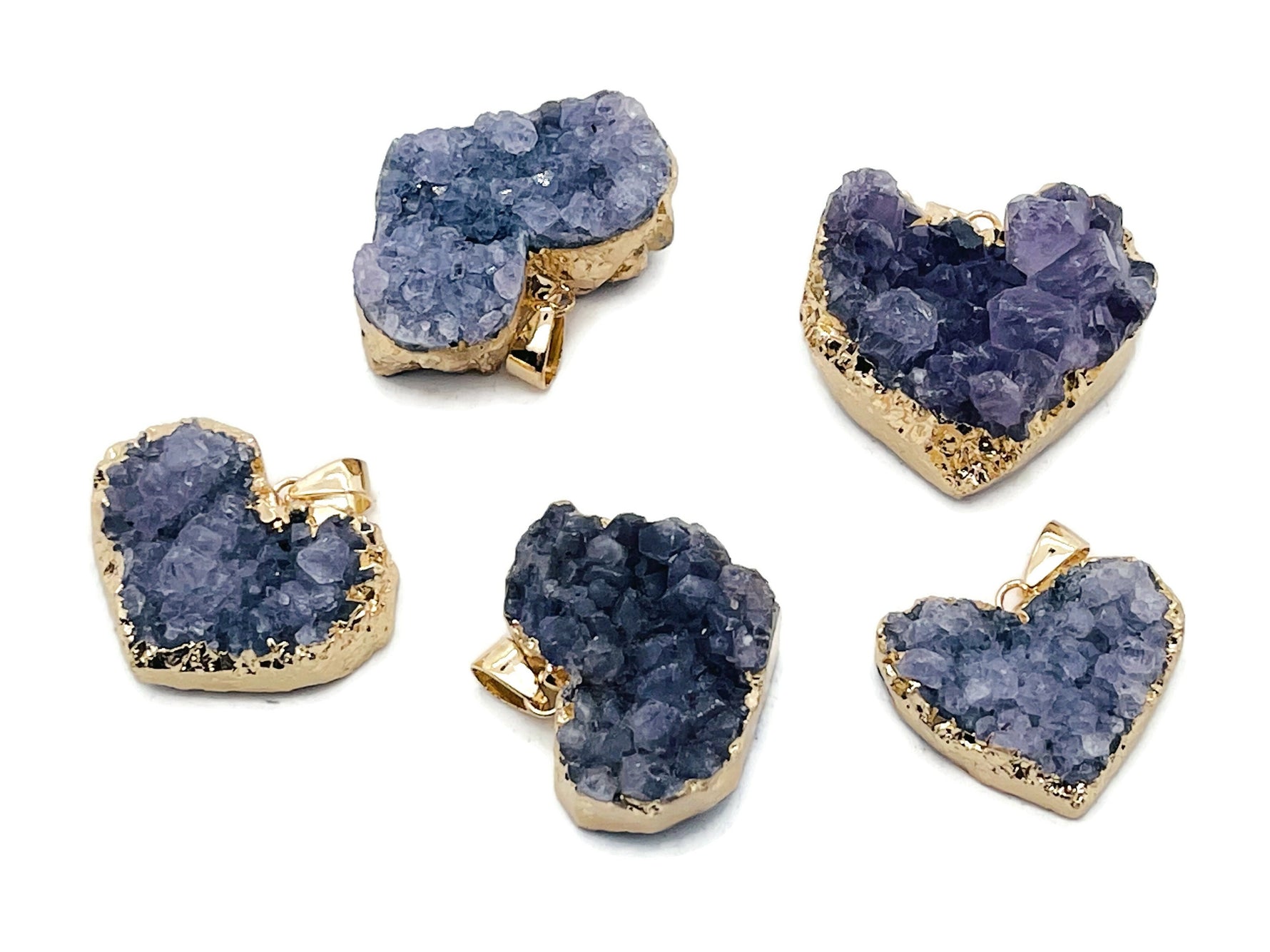 Amethyst heart cluster crystal pendant from GemstoneGO featuring a purple gemstone heart with natural crystal formations.