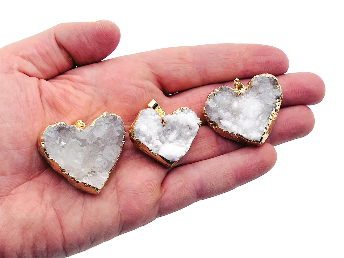 Quartz Heart Cluster Crystal Pendant by GemstoneGO featuring a polished quartz heart-shaped cluster with a silver bail.