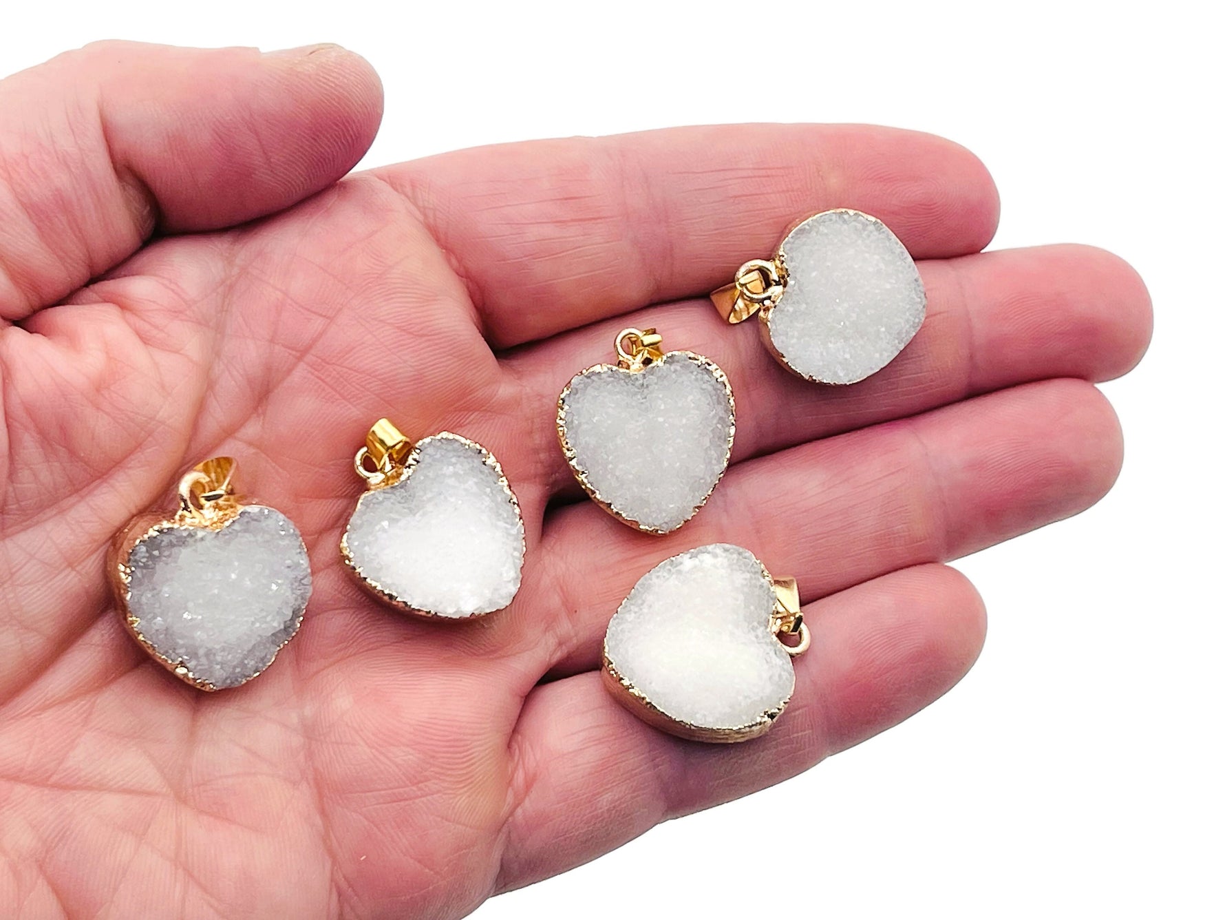White agate heart geode druzy slice crystal pendant with natural gemstone details, displayed on a black background.