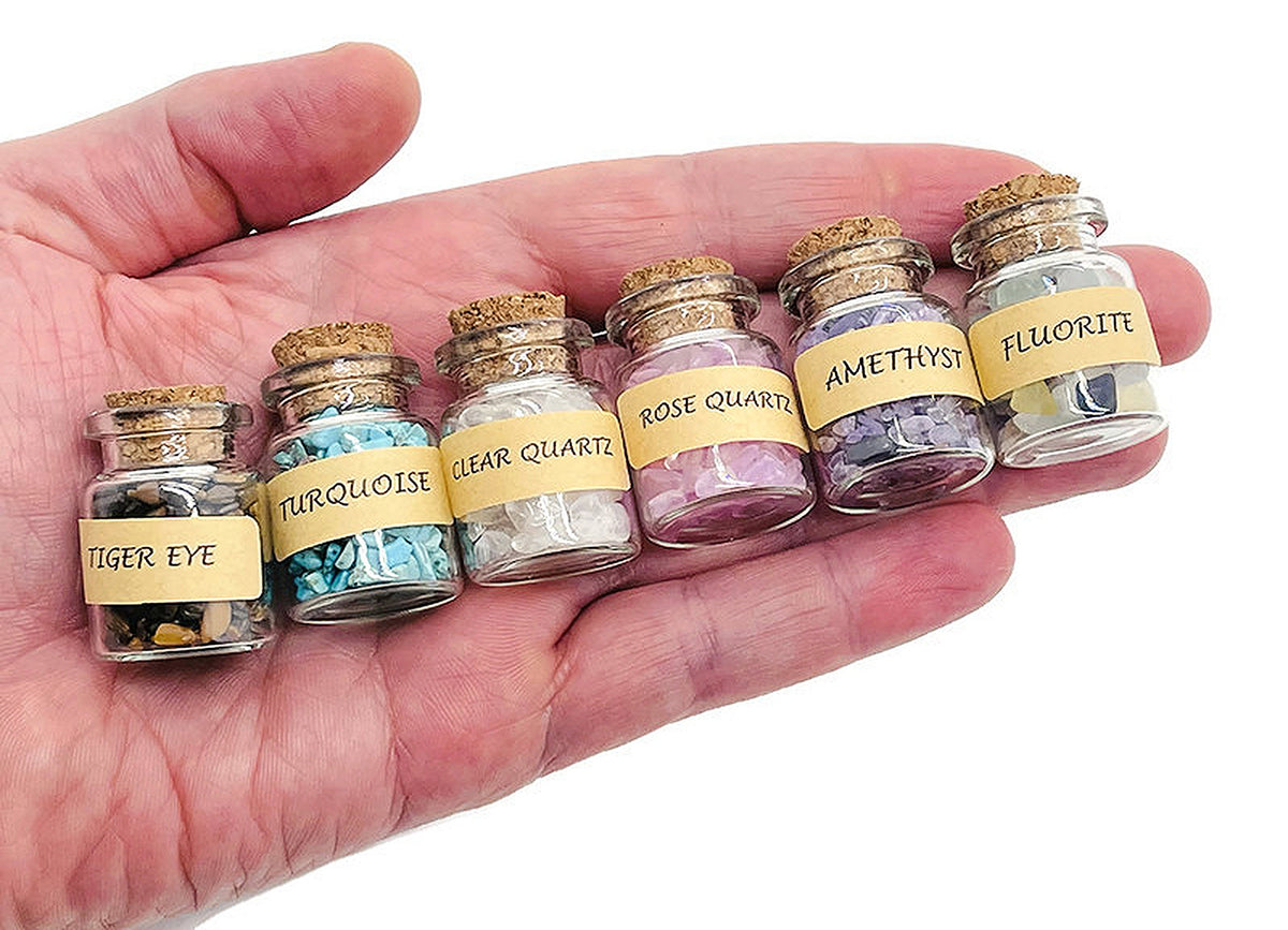 Assorted gemstone chips in a small bottle, including semi-tumbled crystals and energy stones in various colors, from GemstoneGO.