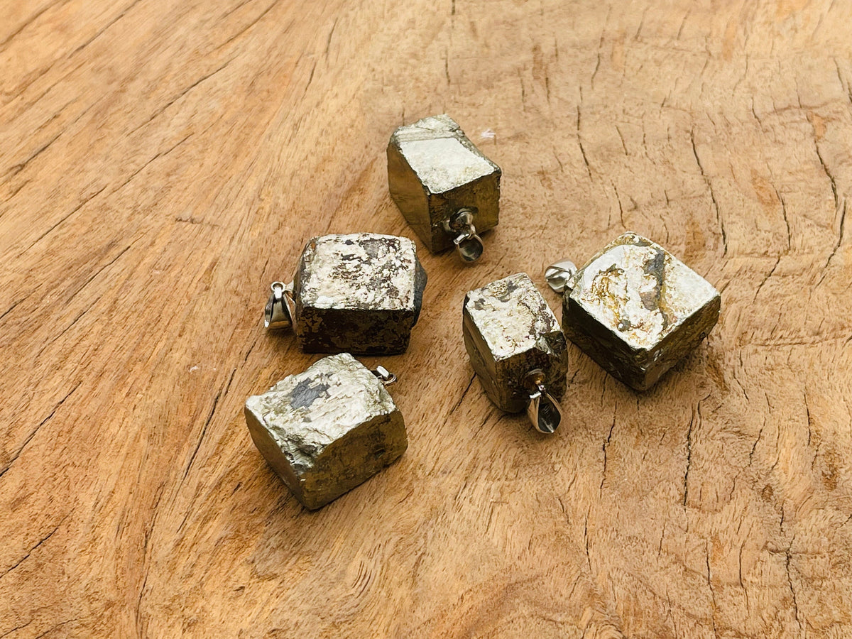 Pyrite crystal pendant from GemstoneGO featuring a metallic gold-toned stone, used as a protection gemstone.