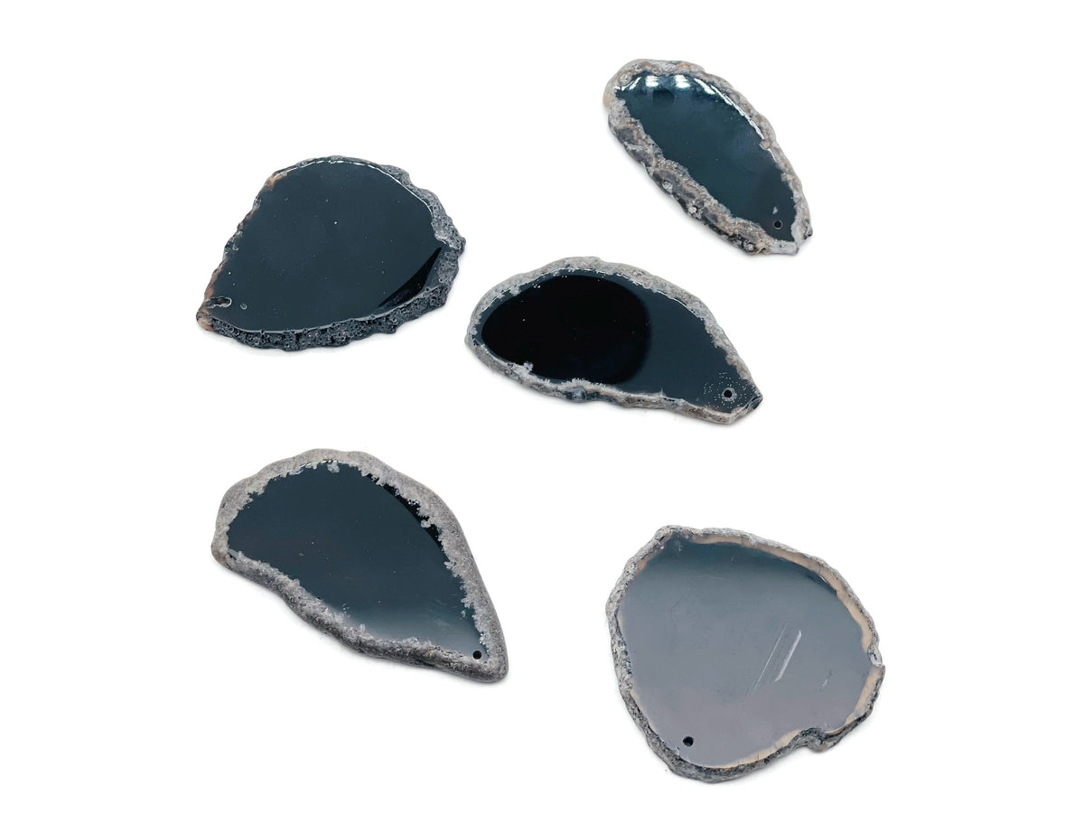 Black Agate slice with drilled hole, geode crystal pendant showcasing polished edges and natural banding patterns.