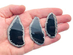 Black Agate Slice drilled gemstone pendant with natural hole, showcasing polished black agate with layered, banded patterns for jewelry.