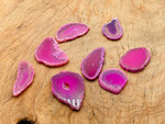 Pink agate slice drilled pendant featuring a natural geode with polished pink stone and a drilled hole for jewelry making.