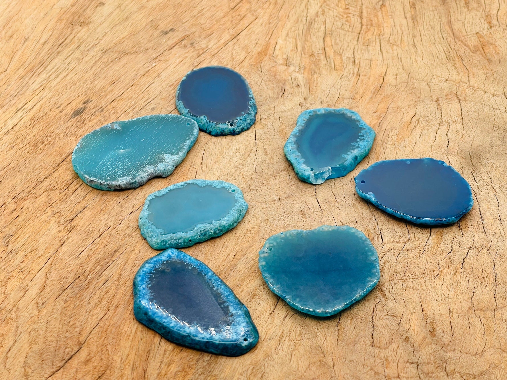 Blue agate slice with drilled hole, geode crystal pendant for jewelry making, showcasing vibrant blue and natural banding.
