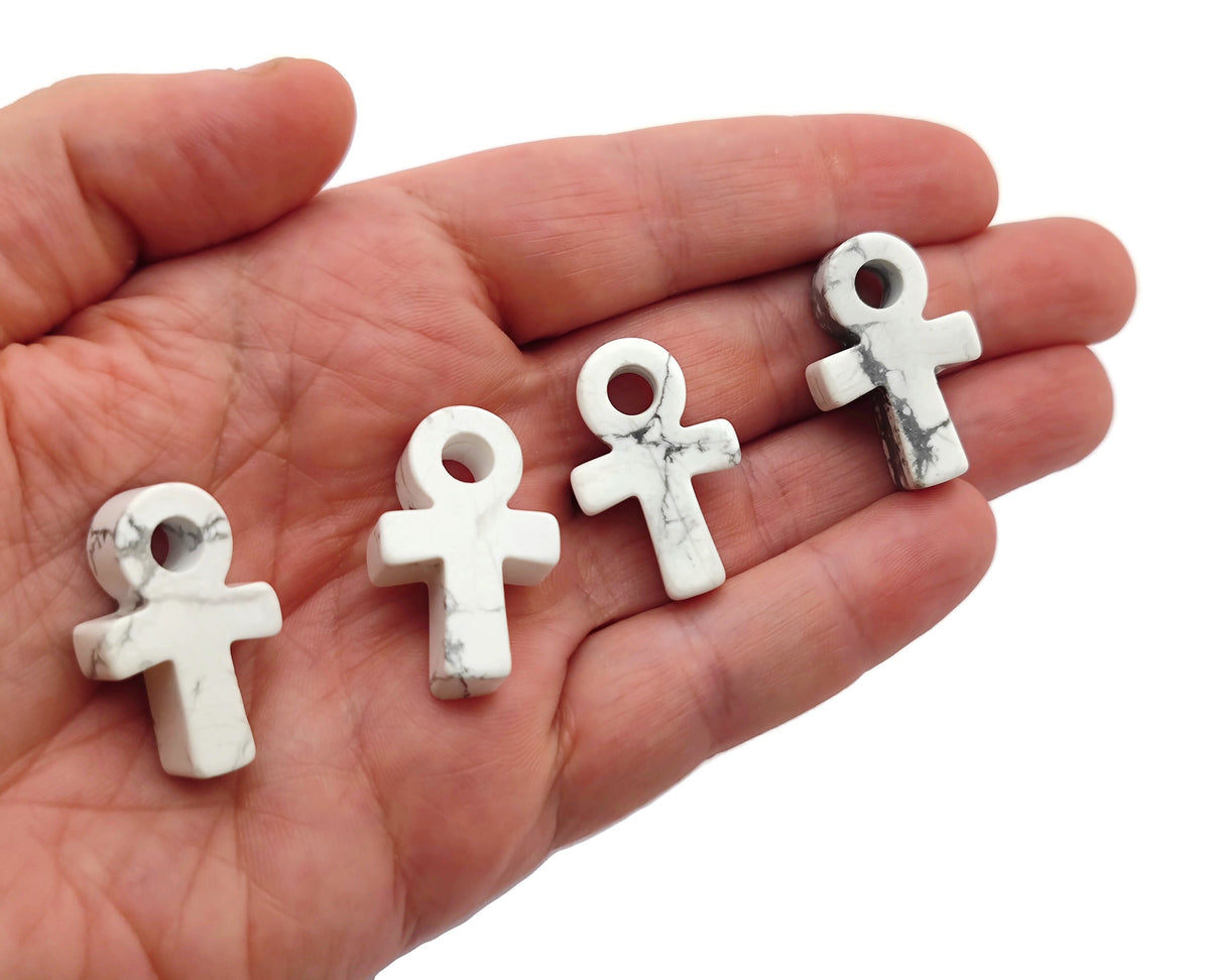 Howlite Anka crystal carving, 30mm gemstone Ankh symbol from GemstoneGO, detailed white and gray stone design.