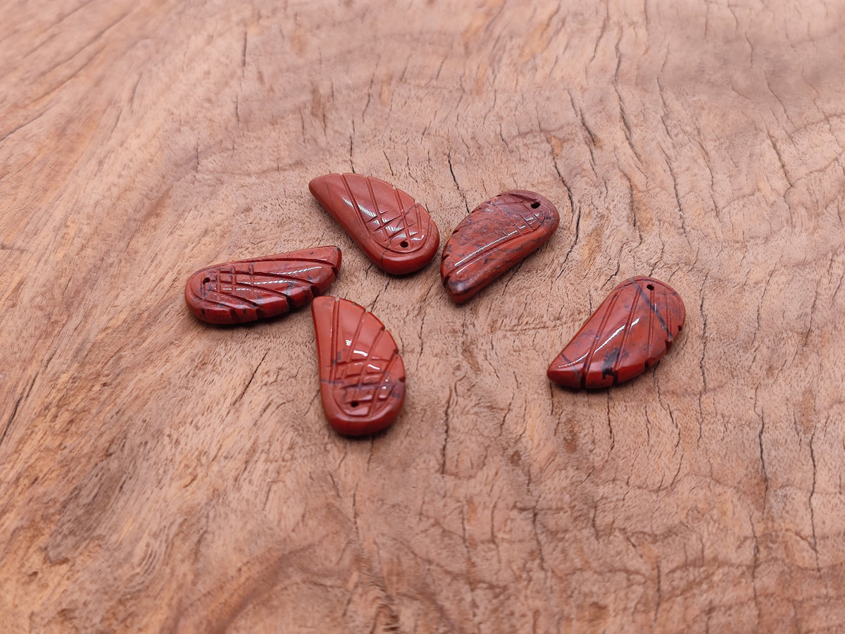 Red Jasper angel wing crystal pendant with hole charm, featuring detailed angel wing design and vibrant red gemstone from GemstoneGO.