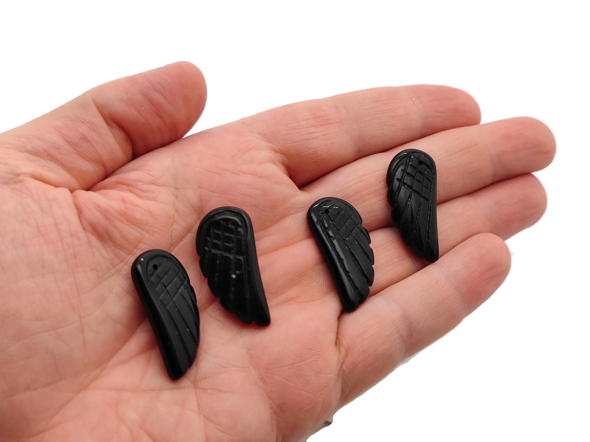 Obsidian angel wing crystal pendant with hole charm, featuring detailed angel wing design on black gemstone, by GemstoneGO.