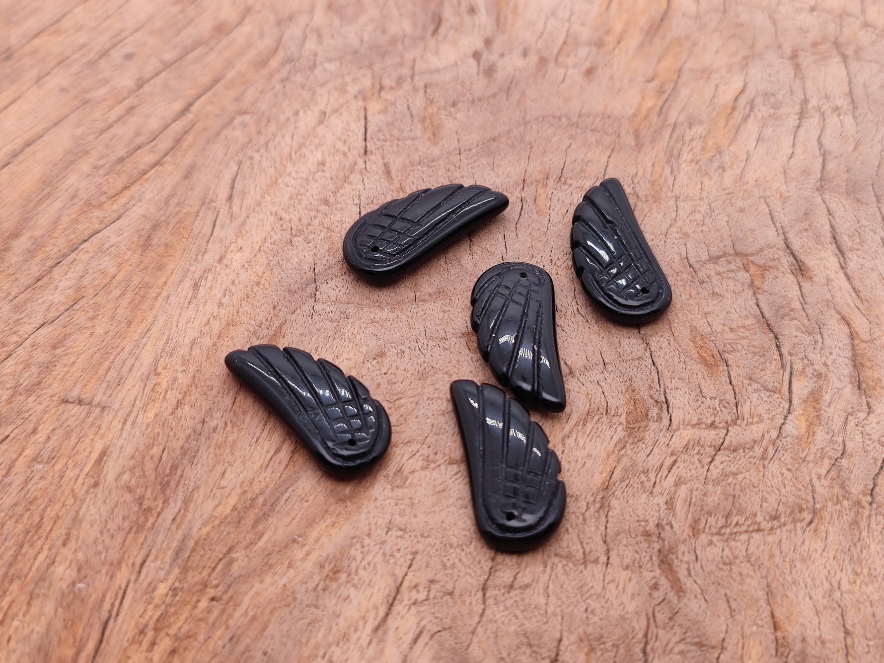 Obsidian angel wing crystal pendant with hole charm, featuring detailed black stone angel wing design by GemstoneGO.