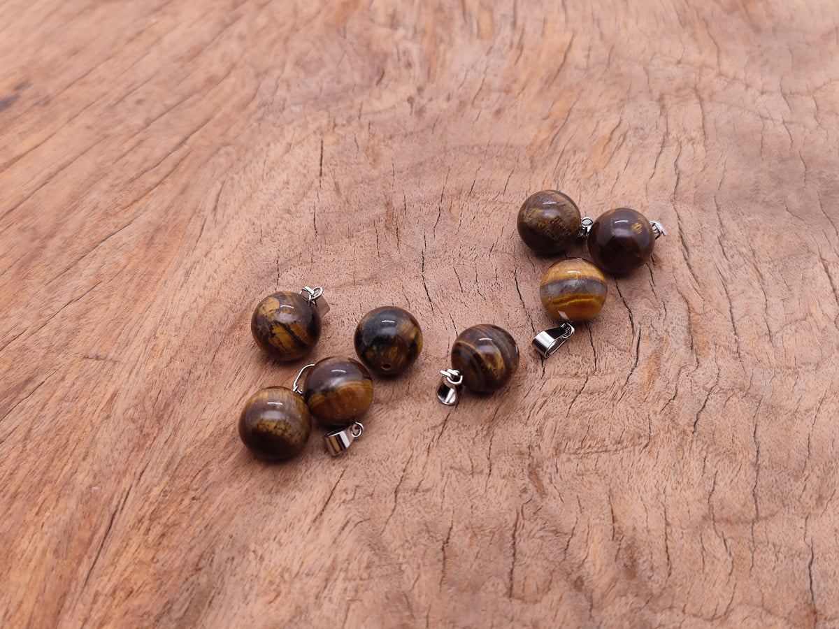 Tige Eye Ball Crystal Pendant by GemstoneGO showing a clear round crystal ball for jewelry making on a neutral background.