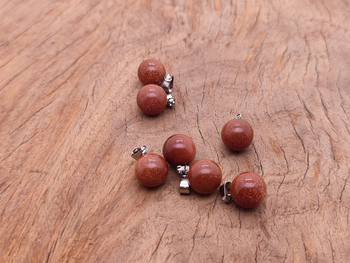 Goldstone ball crystal pendant from GemstoneGO, round jewelry-making pendant with a shimmering goldstone finish.