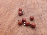 Goldstone ball crystal pendant from GemstoneGO, round jewelry-making pendant with a shimmering goldstone finish.