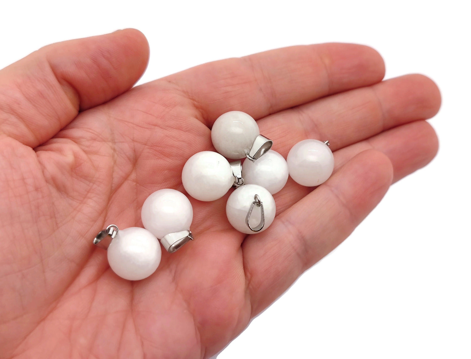 White jade ball crystal pendant from GemstoneGO, round jewelry-making pendant with smooth, polished surface, suitable for necklaces.