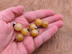 Yellow jade sphere crystal pendant with smooth round shape, ideal for jewelry making by GemstoneGO.