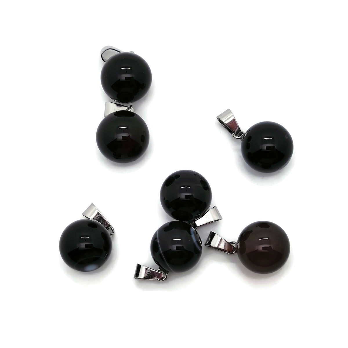 Black agate ball crystal pendant with polished round gemstone, ideal for jewelry making, showing a smooth, glossy surface.