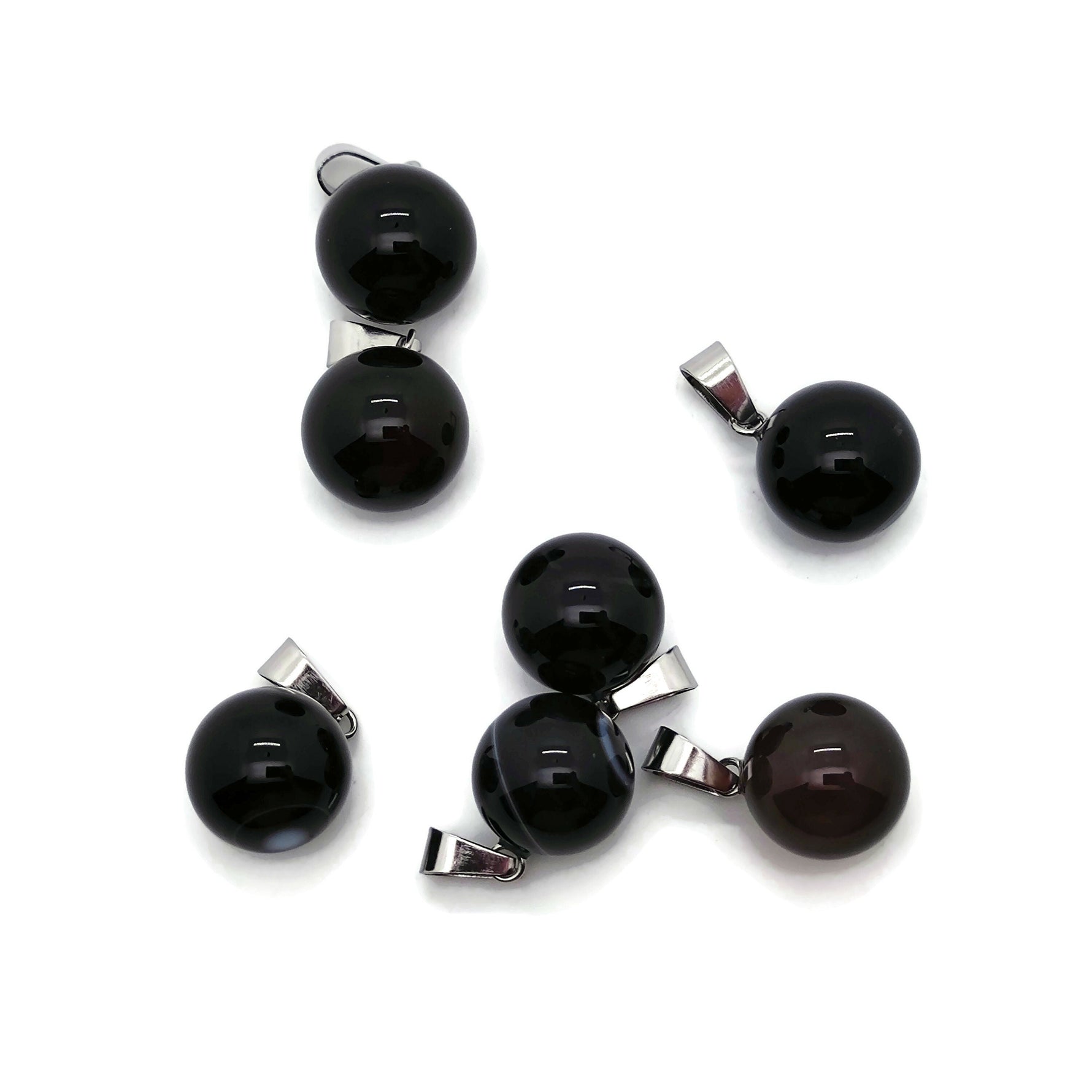 Black agate ball crystal pendant with polished round gemstone, ideal for jewelry making, showing a smooth, glossy surface.
