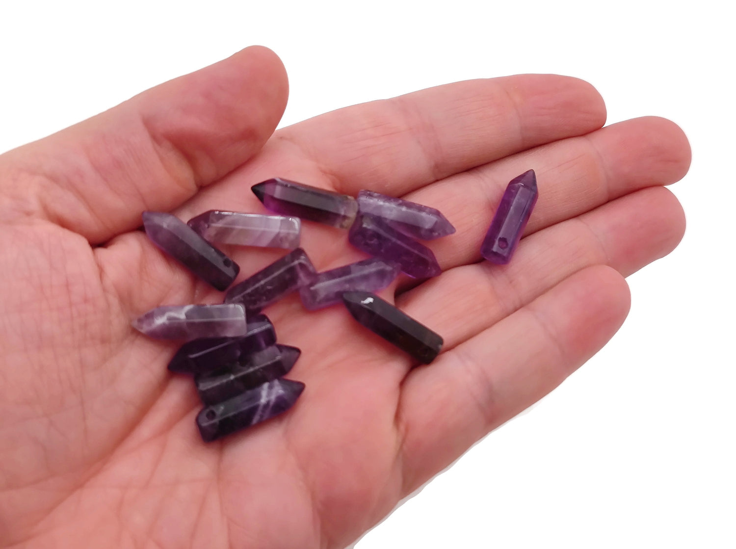 Amethyst point crystal pendant with drilled hole, showcasing purple gemstone and natural crystal formations.