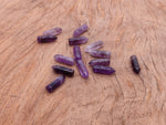 Amethyst point hole crystal pendant from GemstoneGO featuring a drilled purple amethyst crystal with natural facets and polished tip.